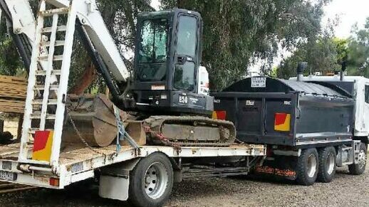 LNJ Excavation excavator on back of truck